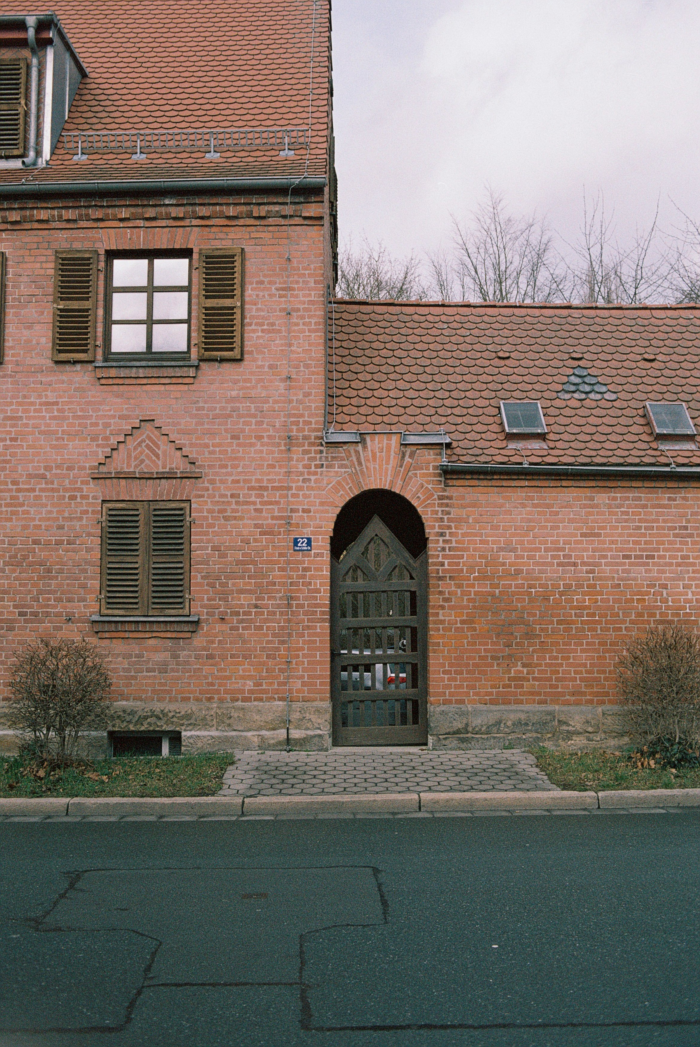 brown brick building with trees in front